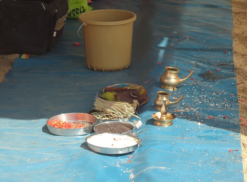 Preparation of items for Bali Tharpanam ritual — darbha grass, sesame seeds, rice, banana leaf and water vessel arranged for Karkidaka Vavu Bali in Kerala